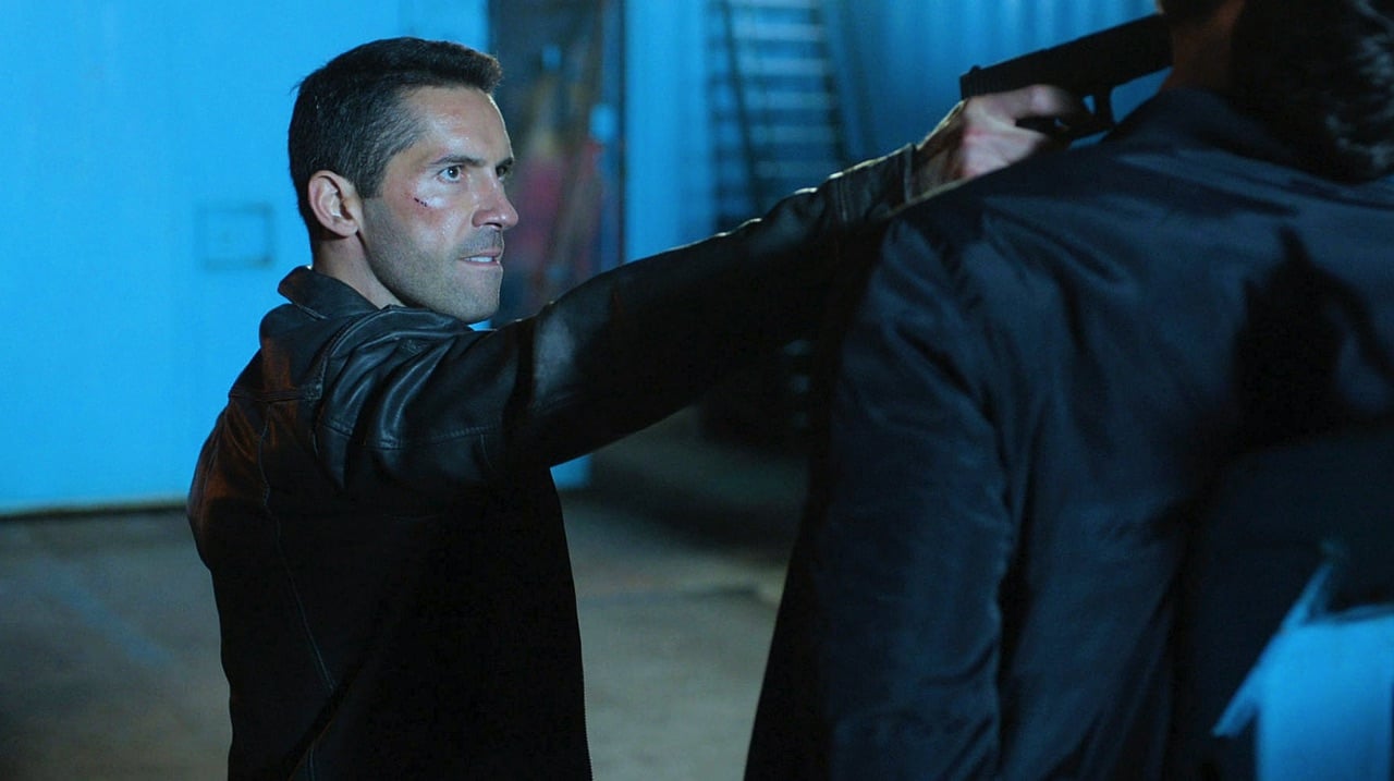 Scott Adkins points a gun