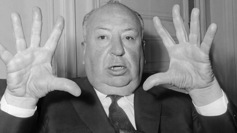 Hitchcock with his fingers splayed