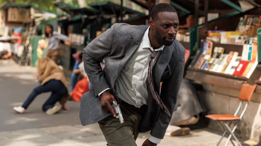 Omar Sey running with gun in hand