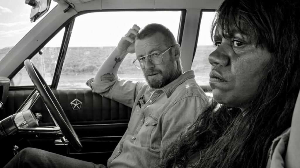 Travis and Emma sitting in a car
