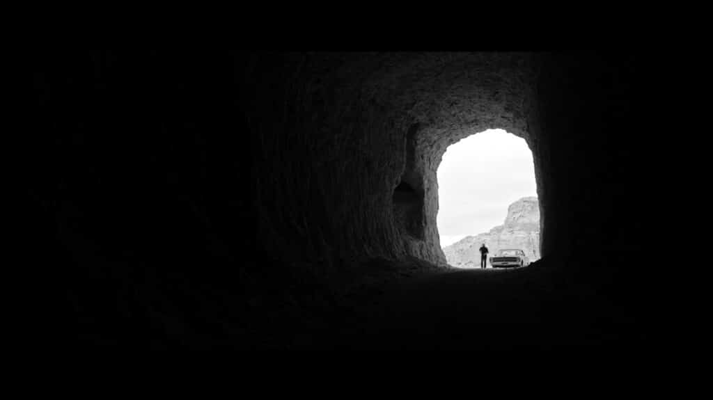 A silhouette at the entrance to a cave