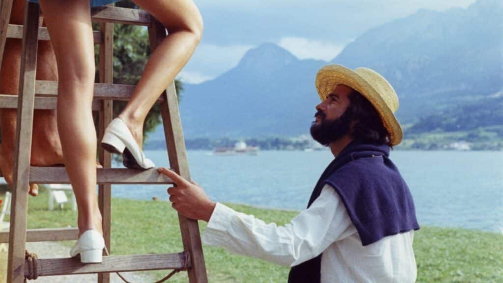 Claire's knee up a ladder, with Jérôme at its base
