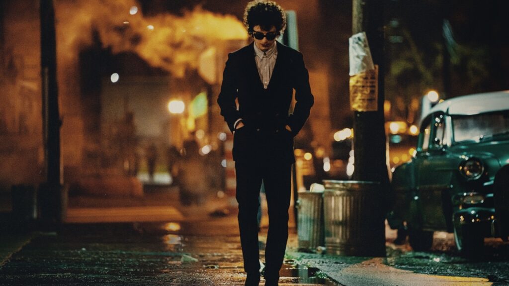 Timothée Chalamet as Bob Dylan walking the nighttime streets