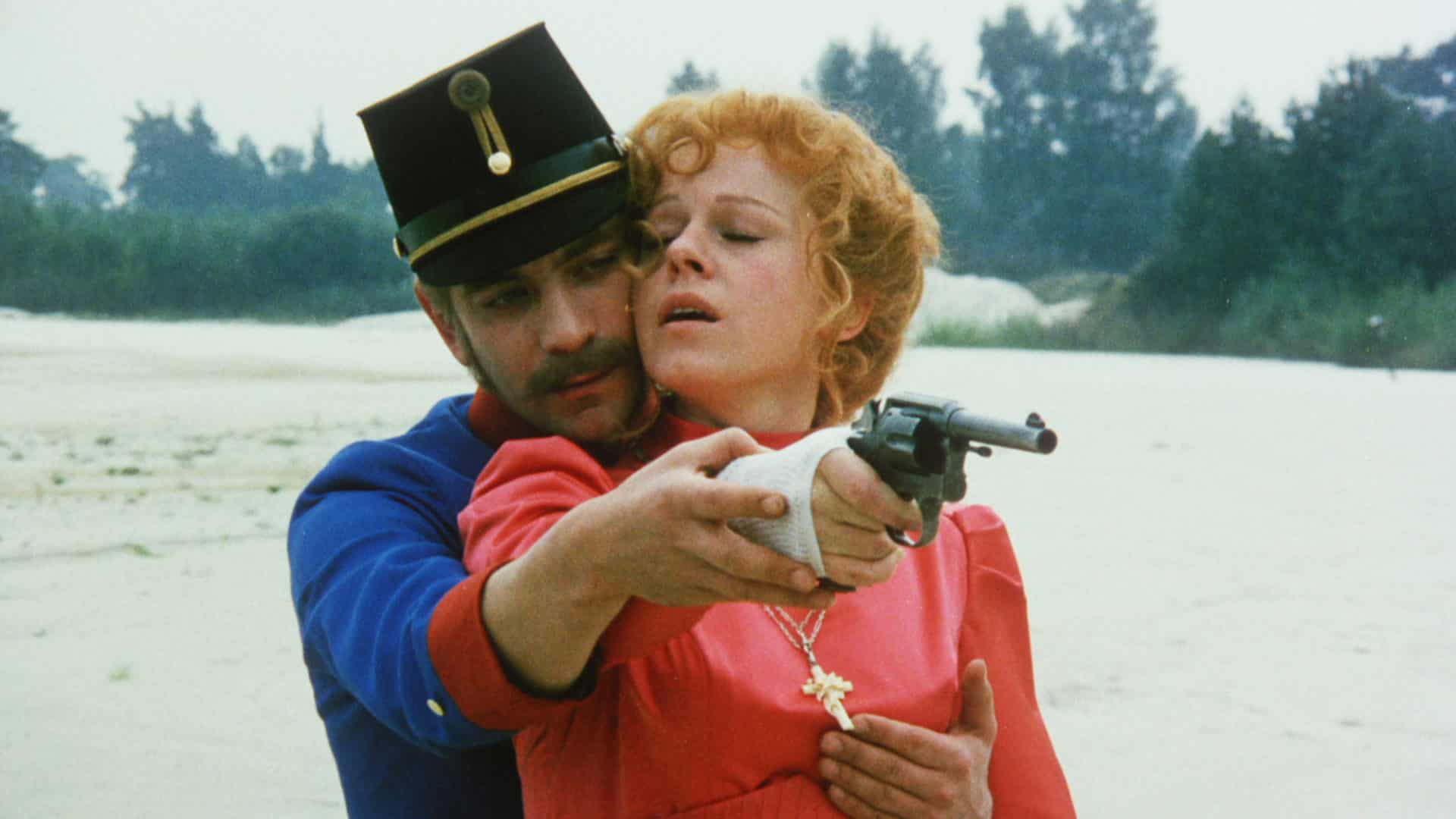 Pavel cups Štěpa's breast as he teaches her to shoot