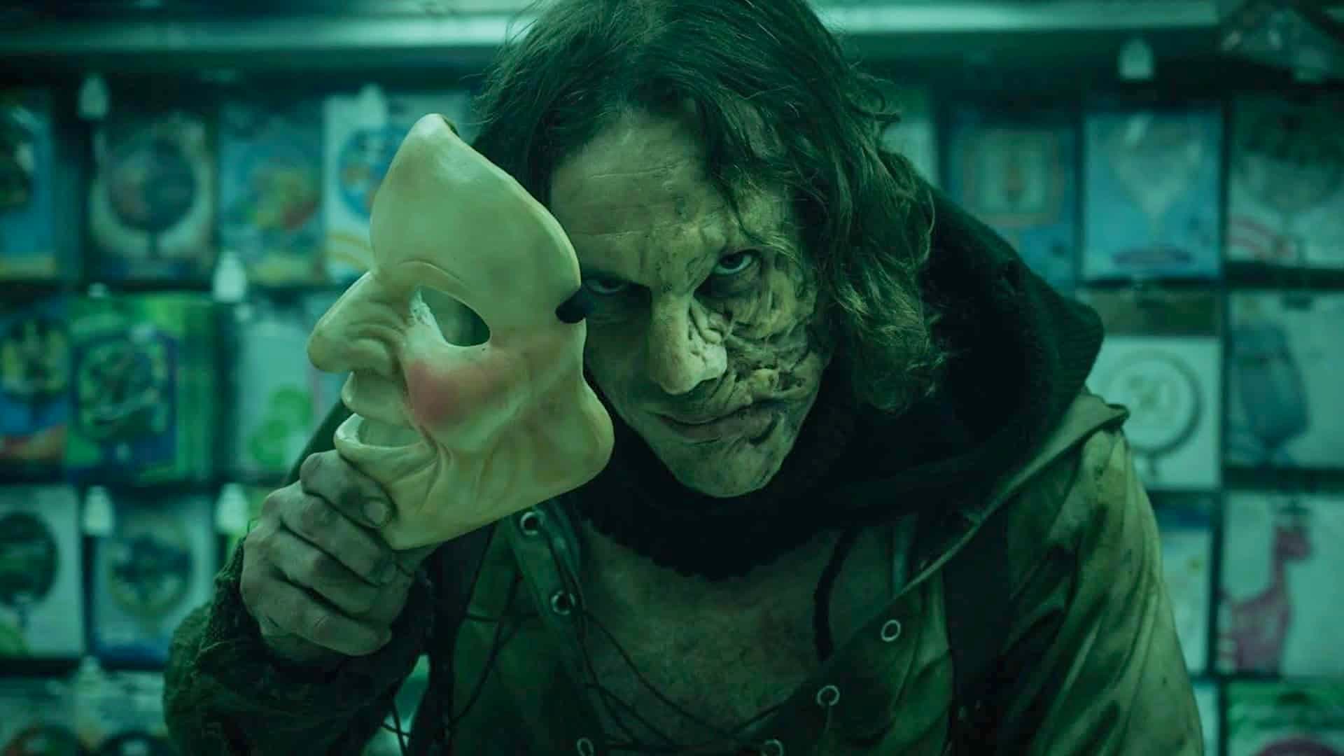 Peter removes his mask to reveal a disfigured face