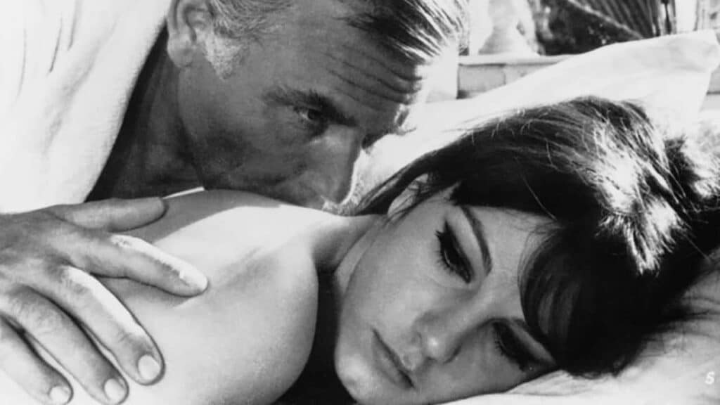 An older man kisses Adriana's back