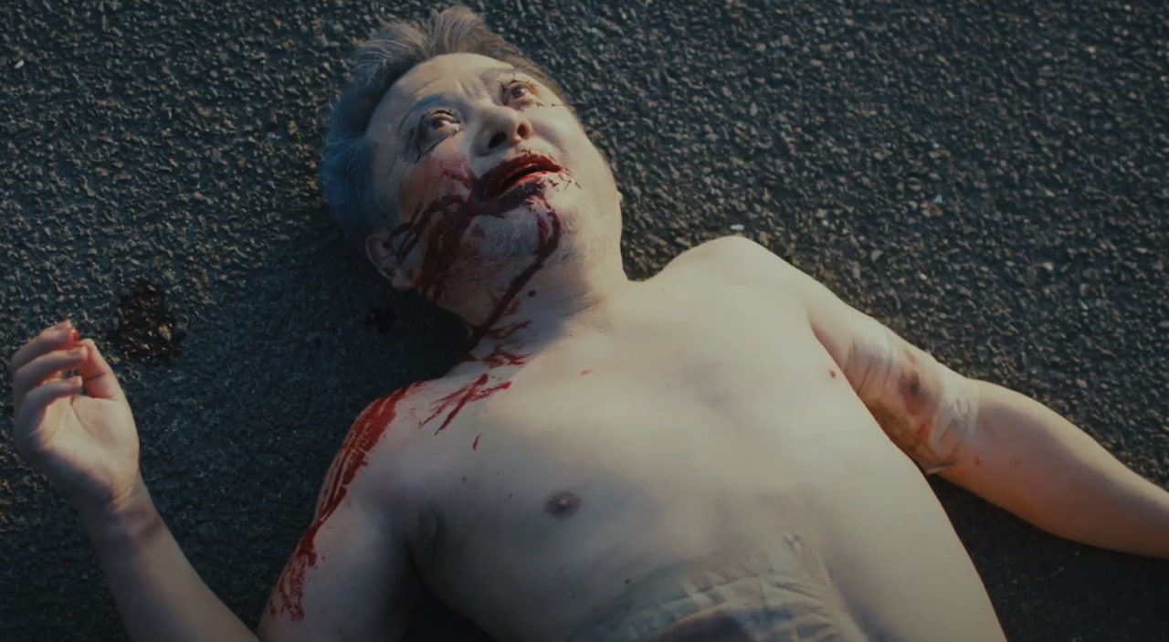 A dead old man lies on the ground