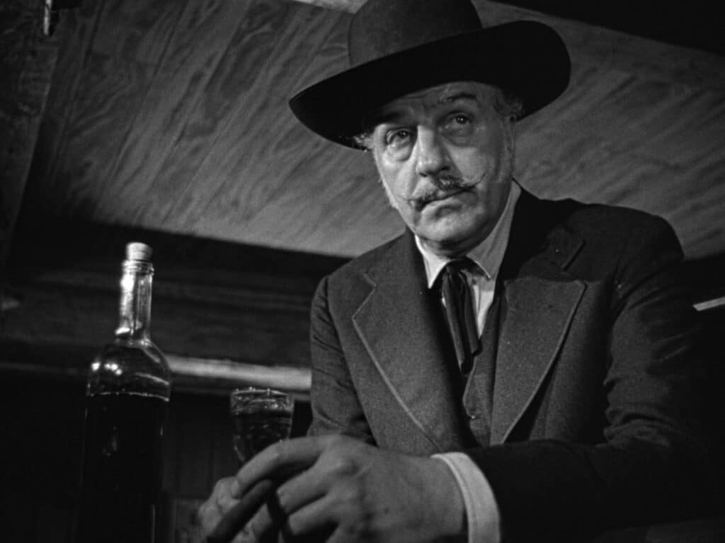 Louis Calhern with a bottle and glass of whiskey