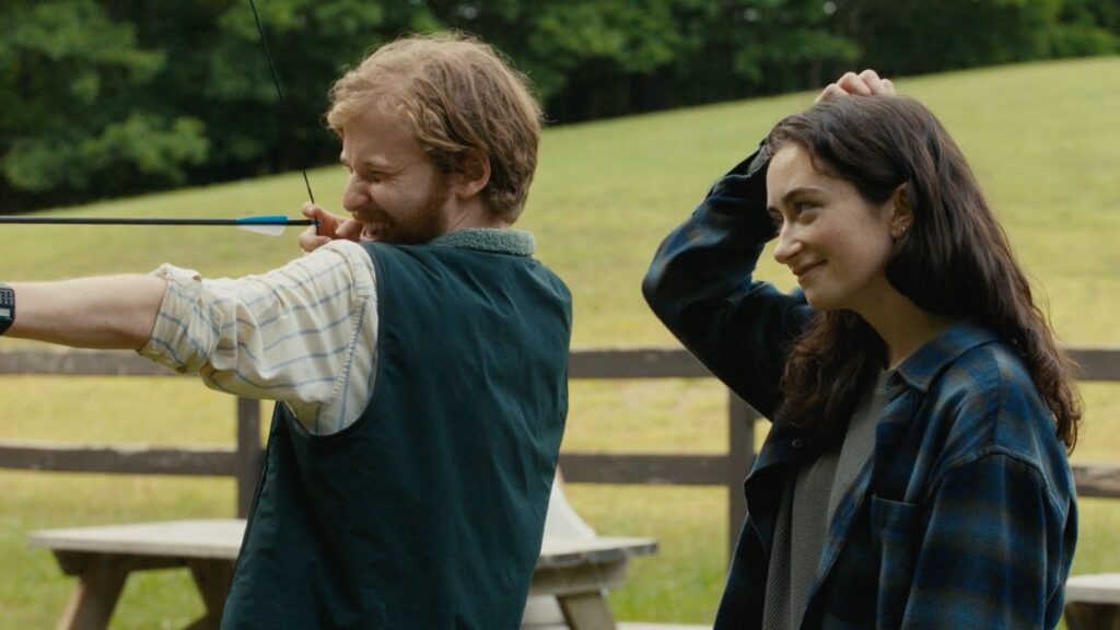 Jason aims an arrow while Claire looks on