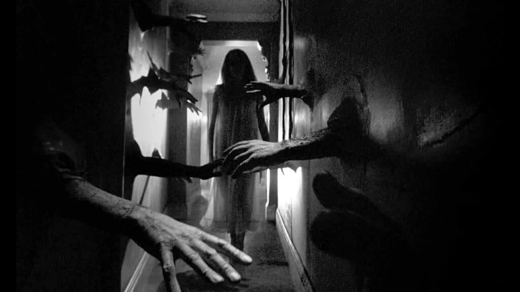 Carol walks through a corridor full of fumbling arms