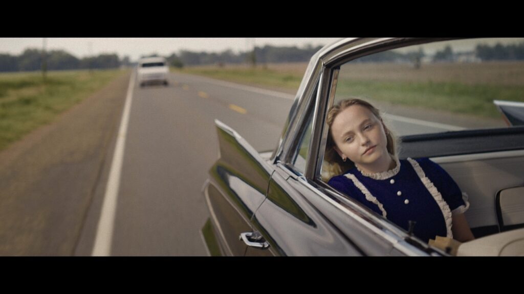 Annie in the back of her parents' car