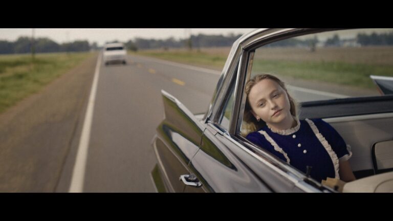 Annie in the back of her parents' car