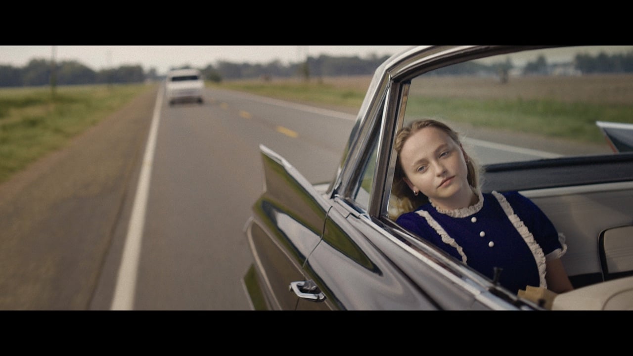 Annie in the back of her parents' car