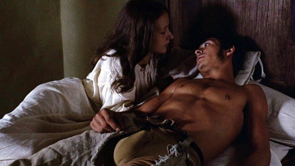 A young woman and man in bed together