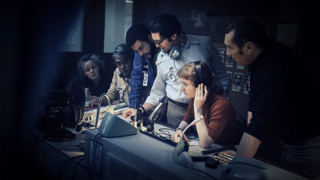 Leonie Benesch as the secretary surrounded by men