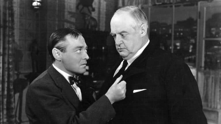 Pter Lorre grabs Sydney Greenstreet's lapel