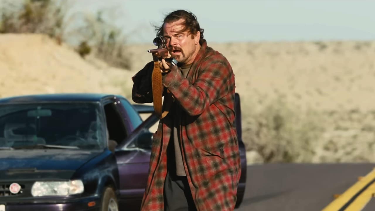 Bob (Leonardo DiCaprio) aims a rifle