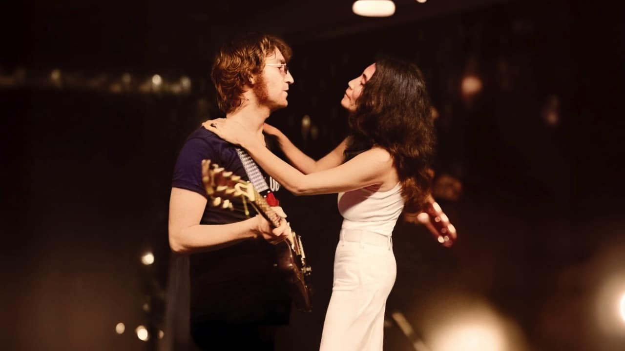 John and Yoko embrace on stage