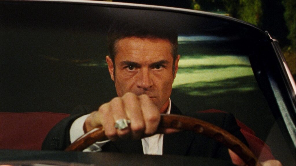The young John D driving a car