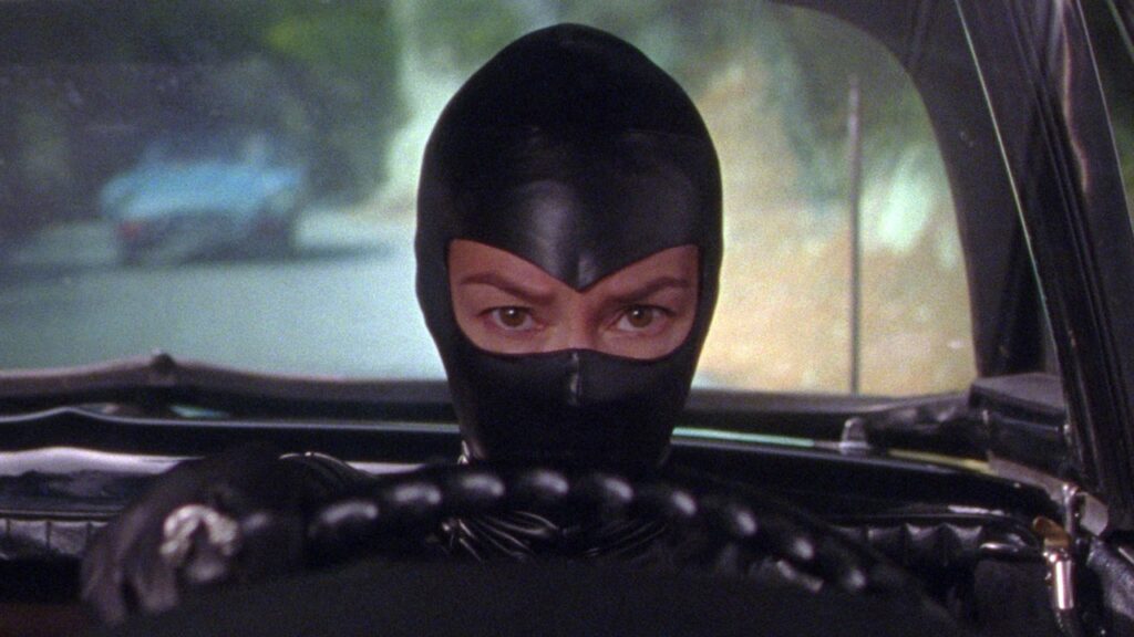 A masked Serpentik behind the wheel of a car