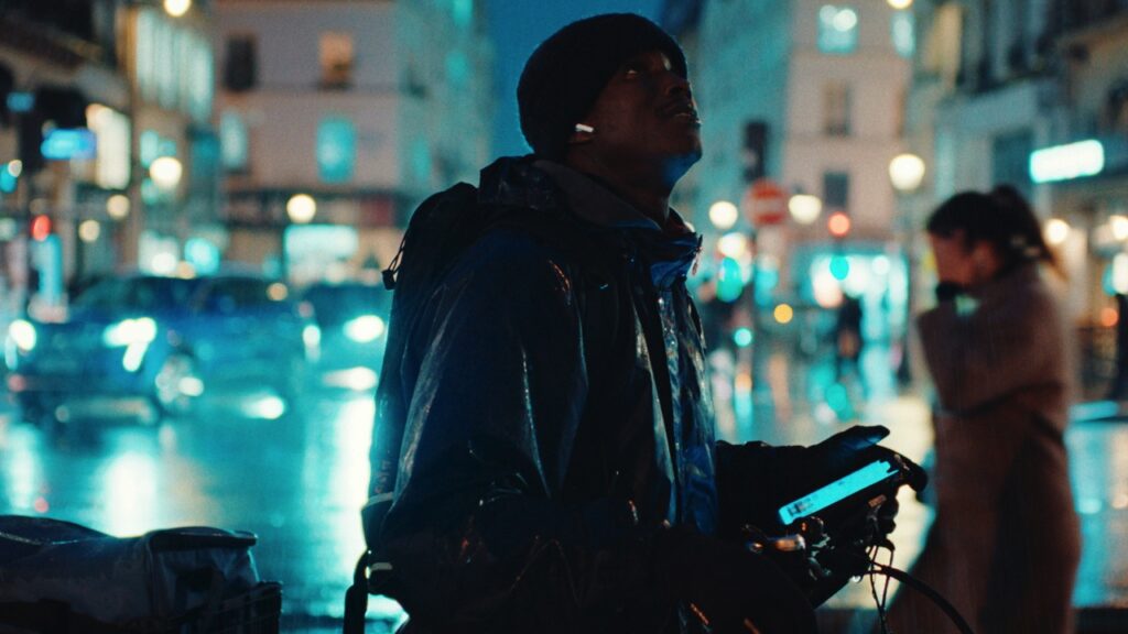Souleymane on a city street at night