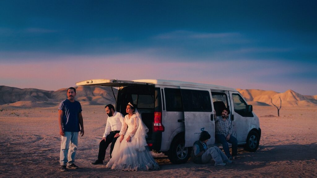 Group shot in the desert with people carrier