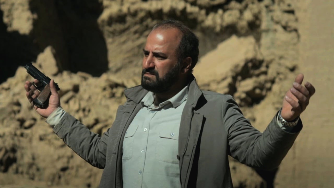 Dad Iman with a gun in his hand