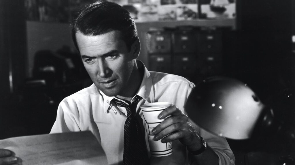 McNeal in shirtsleeves with a coffee