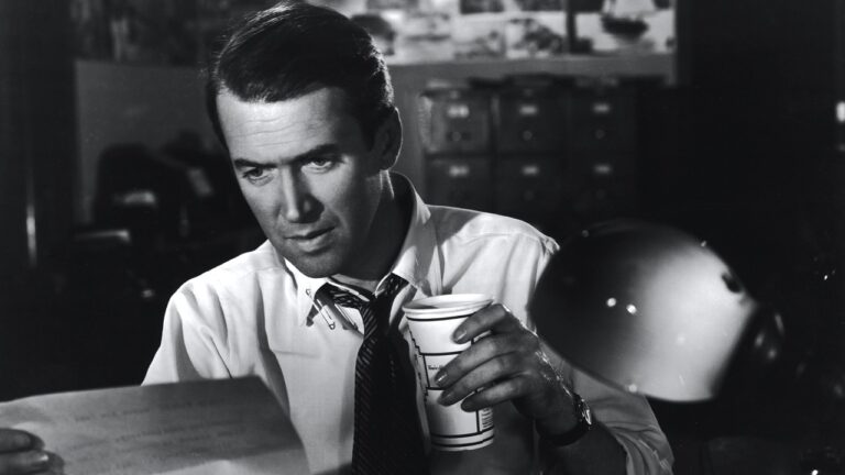 McNeal in shirtsleeves with a coffee