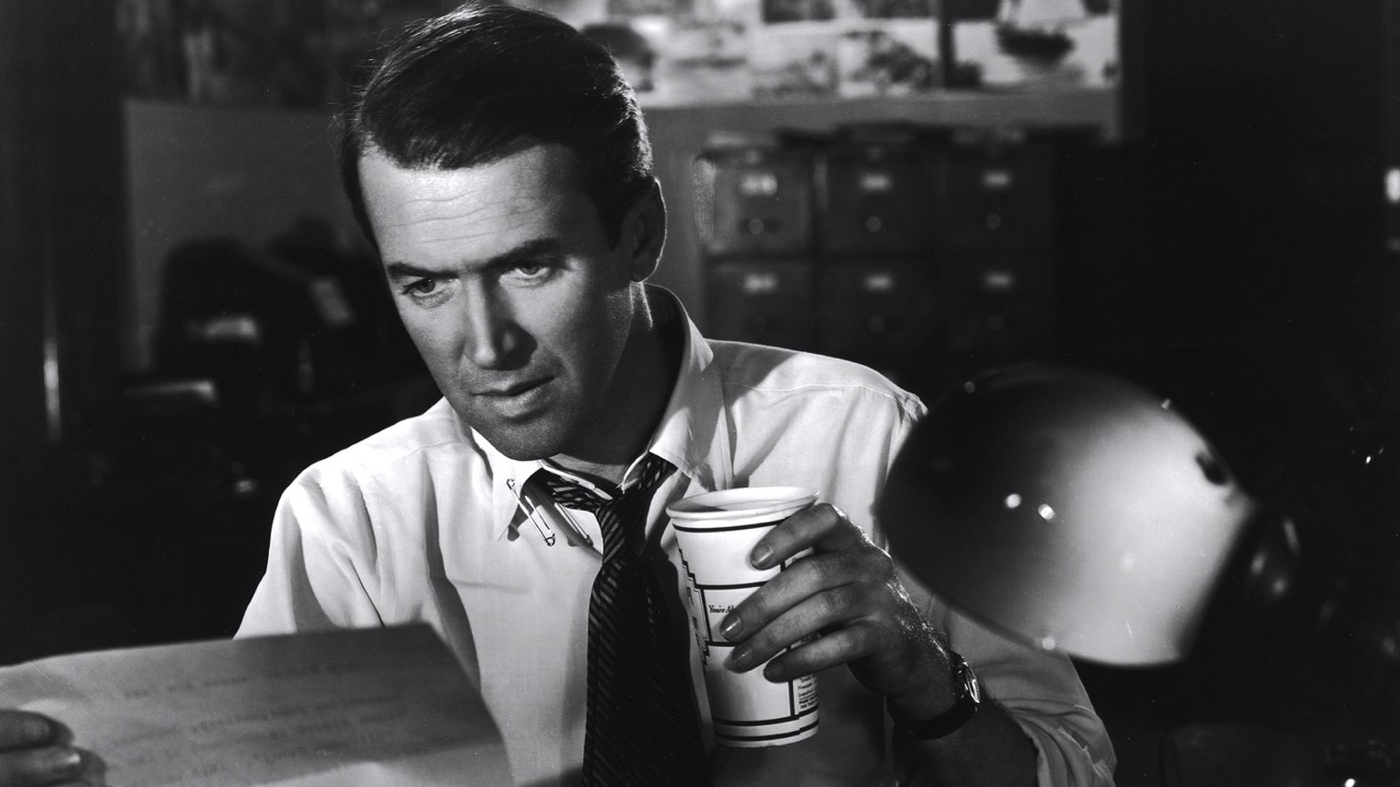 McNeal in shirtsleeves with a coffee