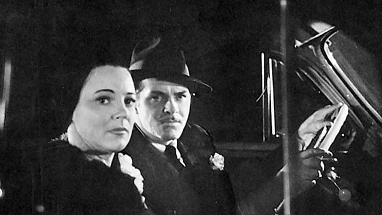 Marian in a car with DA Lawrence Dale