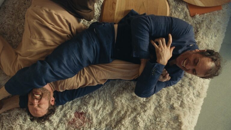 Carey and Paul grapple on the floor
