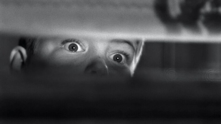 Tommy, wide-eyed, witnesses the murder