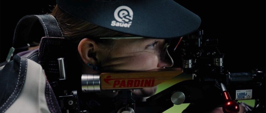 Alex lines up her rifle sights on a target