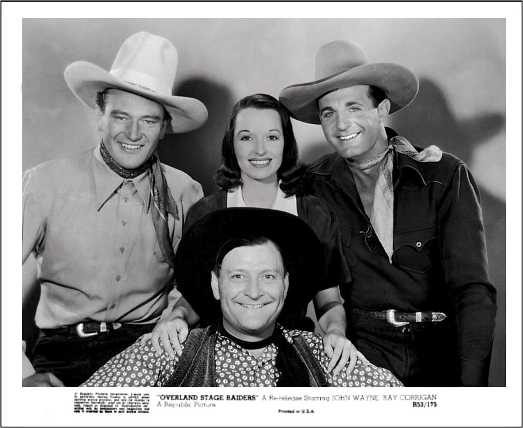 Group shot of Wayne, Corrigan and Terhune with Louise Brooks