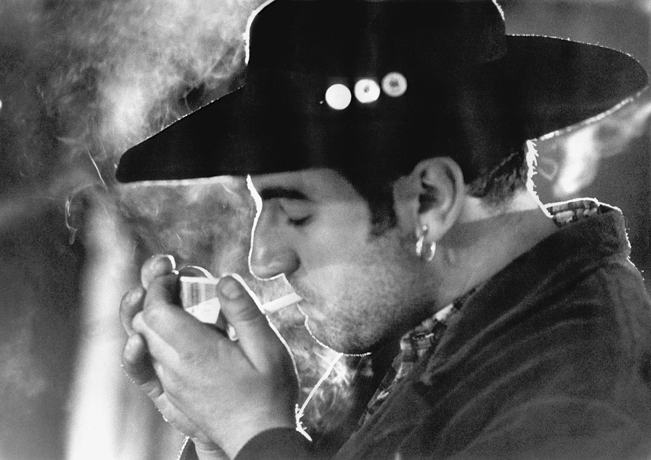Balla lights a cigarette