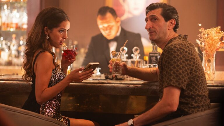 The younger girlfriend and a bewildered George at a bar