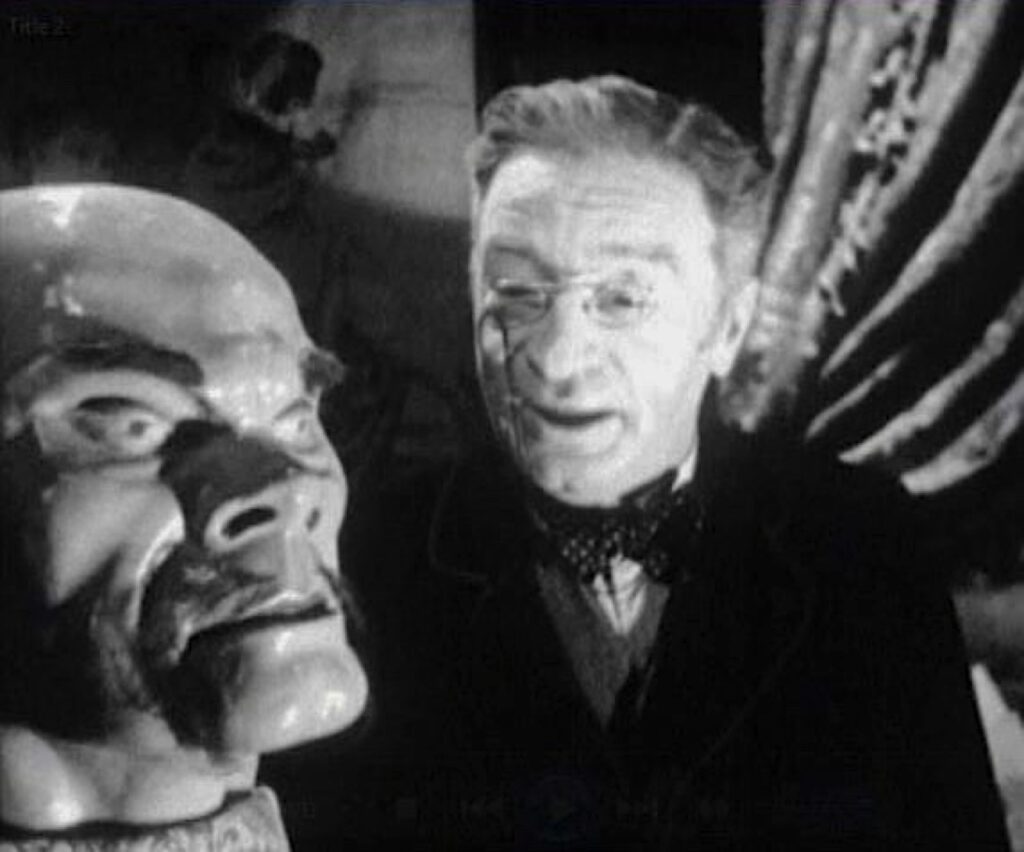 A striking artificial head in the foreground with a narrator speaking