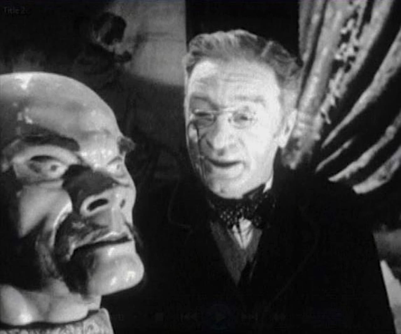 A striking artificial head in the foreground with a narrator speaking