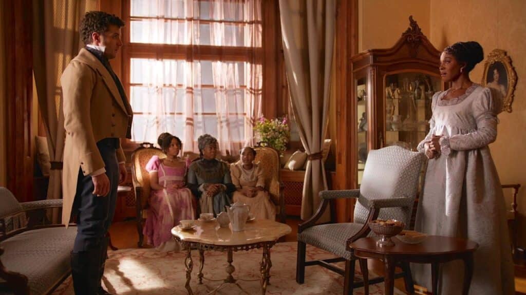 Edward and Elinor in the foreground, with the Dashwoods looking on