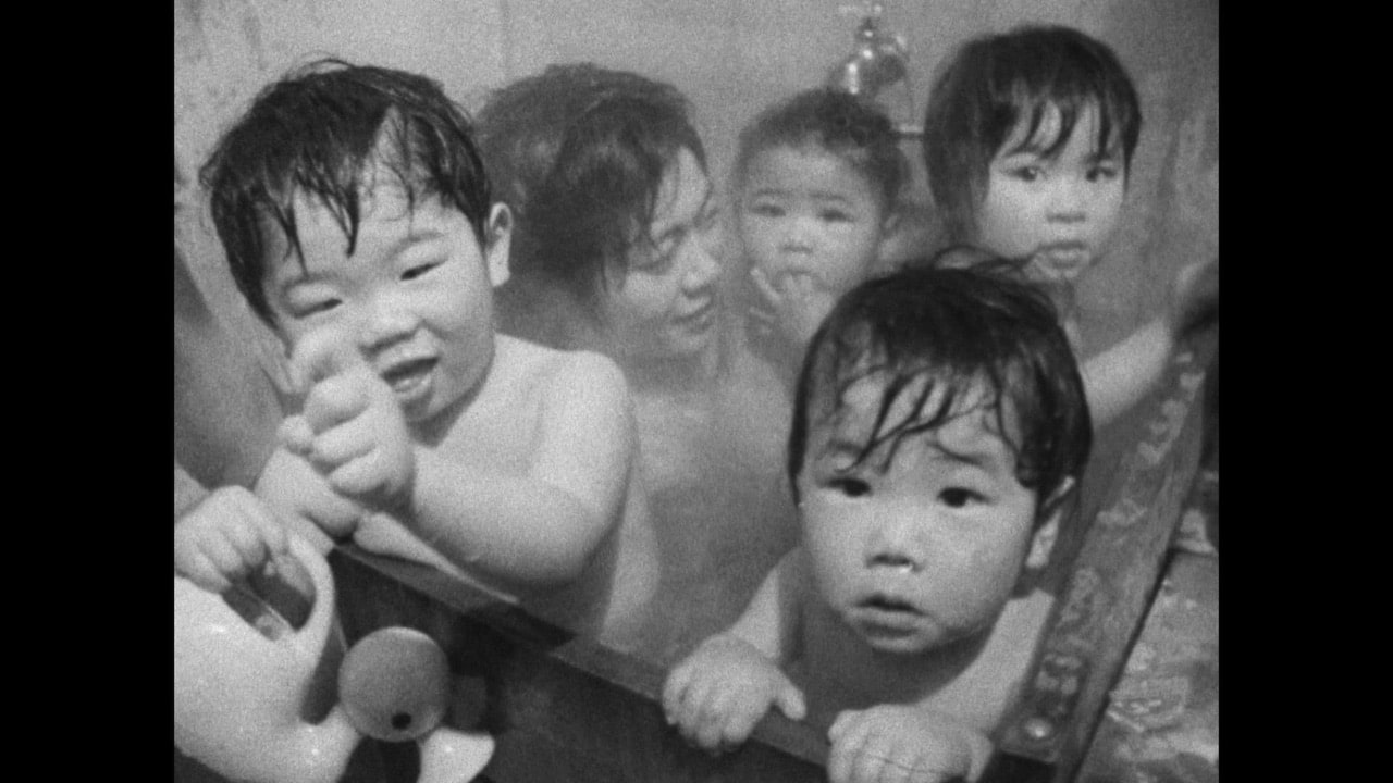 Miyuki in a bath with other bargirls' babies
