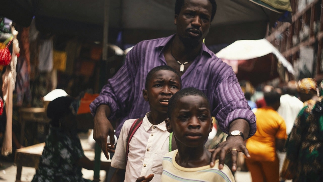Dad guides the boys through a busy market
