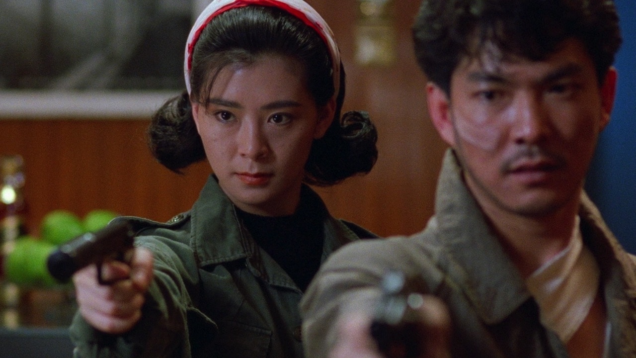 Chui Pai and Heung Ming aim guns towards the camera