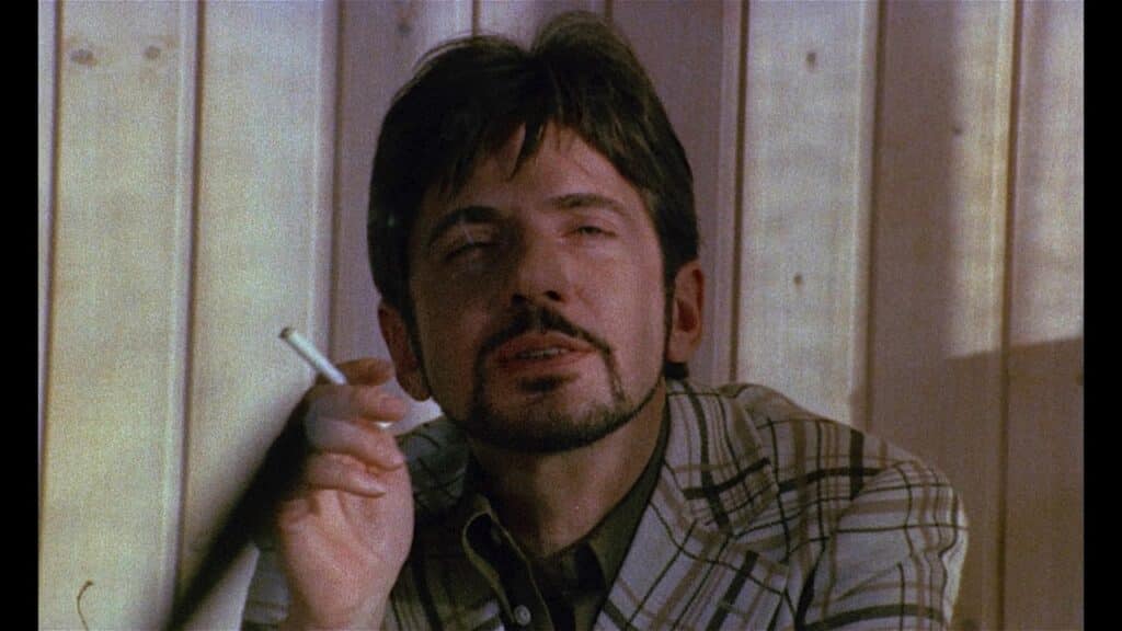 Tony smokes a cigarette