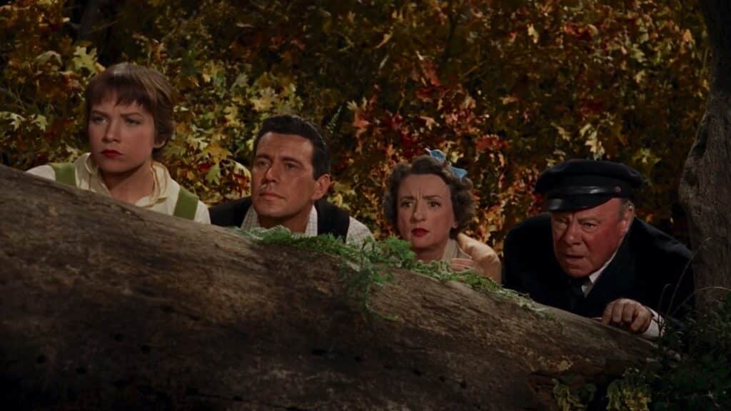 Mrs Rogers, Sam, Miss Gravely and the captain hide behind a falled tree