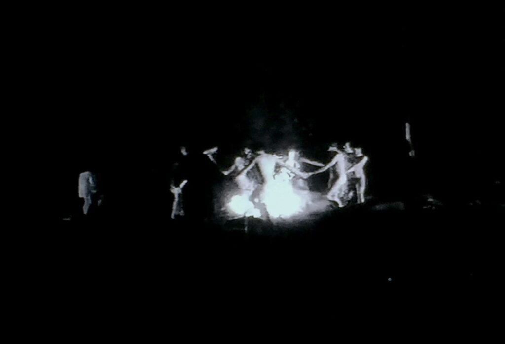 Naked witches dancing around a fire